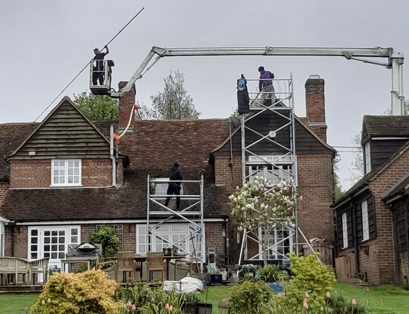 The Roof Moss Cleaners using cherry picker and scaffolding to clean roof safely and professionally in Marston Moretaine, Bedfordshire